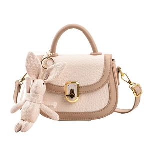 Minimalist beige and light brown patchwork saddle bag with gold oval twist lock closure