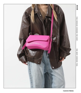 Fashionable rose pink crossbody bag in litchi texture PU leather worn by a model