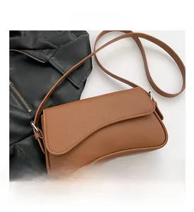 Detailed view of the brown lychee pattern leather shoulder bag with sleek silver hardware