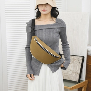 Detail of khaki waterproof canvas chest bag with adjustable black strap and buckle