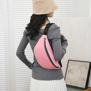 Detail of pink waterproof crossbody bag with black adjustable strap and metal zipper