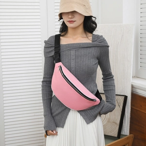 Detailed view of pink water-resistant fabric and silver zipper of this casual chest bag