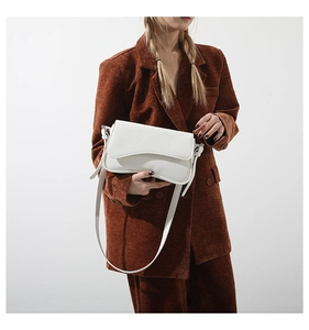 Detail of white lychee texture PU leather bag with wave curve flap and adjustable strap