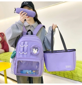 Detailed view of purple nylon backpack set with tote bag and clear window display