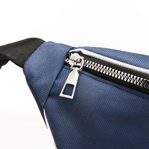 Detailed macro view of the silver metal zipper and durable navy blue canvas fabric texture