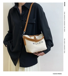 Détail du sac seau en paille tressée avec bandoulière en cuir et broderie RESTAIN