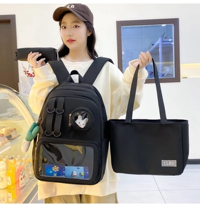 Three-piece black nylon backpack set with tote and pencil case shown on a model