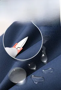 Detail of dark blue waterproof fabric with woven texture showing scratch resistance