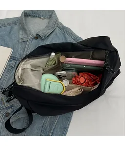 Internal view of black canvas crossbody bag showing large storage capacity for essentials