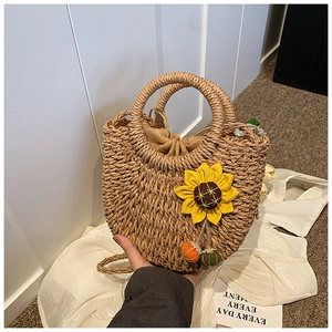 Straw shoulder bag with woven texture, round handles and sunflower charm decorations