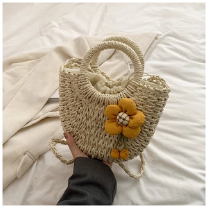 Fashionable woven straw shoulder bag with sunflower accent and drawstring closure