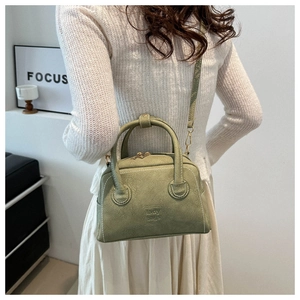 Detail of vintage green PU leather crossbody bag featuring embossed lady bags text on the surface