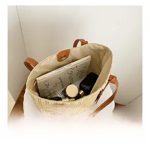 Top view of beige straw tote bag showing spacious interior and magnetic snap closure