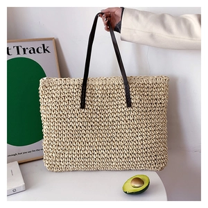 Fashionable woven straw tote bag with brown leather straps for spring and summer style
