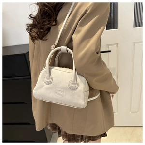 Detail shot of vintage cream white PU leather Boston bag with lady bags logo embossing