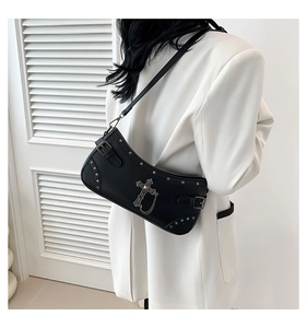 Side view of a black punk PU leather crossbody bag with silver cross and metal chain