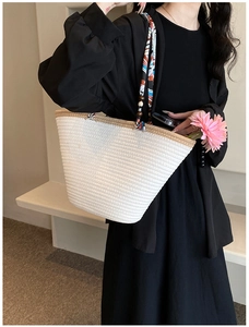 Détail d'un sac fourre-tout tissé blanc avec anses imprimées colorées et perles en bois