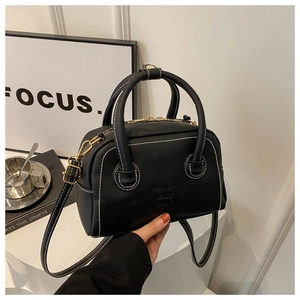 Chic black PU leather Boston handbag with contrast white stitching and gold hardware
