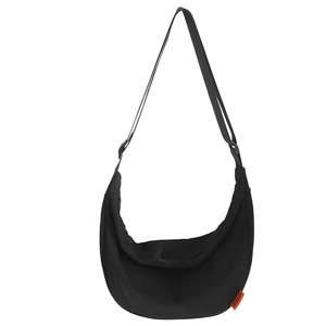 Minimalist black crescent nylon crossbody bag with adjustable strap and orange label