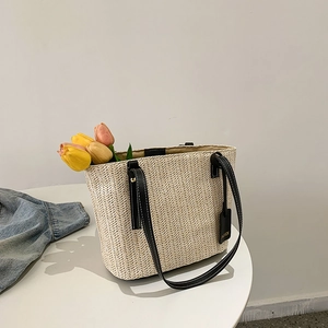 Chic 2024 spring straw woven tote bag in beige with black leather handles and floral decor