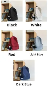 Detailed grid view showing five colors of nylon backpacks with plush monkey charms