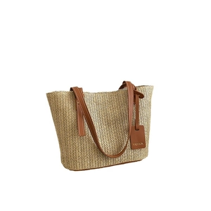 2024 minimalist straw tote bag with brown leather handles and fashion tag on white background