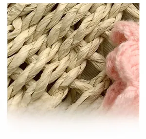 Macro shot of natural woven straw texture with pink crochet flower detailing