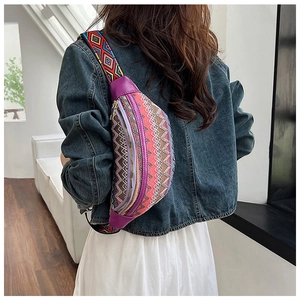 Detail of bohemian crossbody bag with colorful geometric woven strap and purple fabric