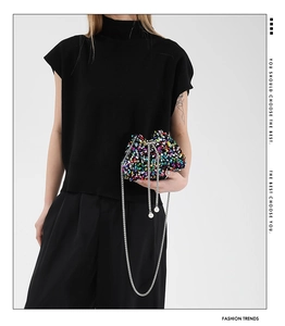 Detail showing colorful sequins, drawstring closure with pearl bead and chain strap