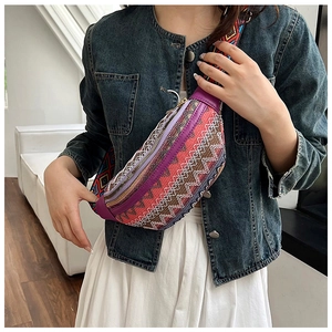Close-up of bohemian woven crossbody bag with geometric patterns and purple leather trim