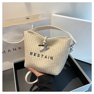 Fashion woven bucket bag in cream white with RESTAIN embroidery and leather handle