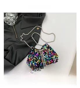 Detail view of colorful sequin bucket bag with silver chain strap and pearl drawstring ties