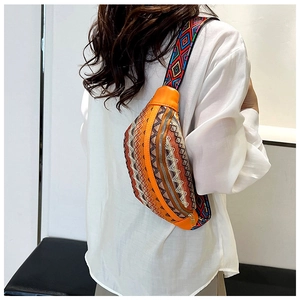 Detail of bohemian waist bag with orange leather and ethnic embroidery on wide strap