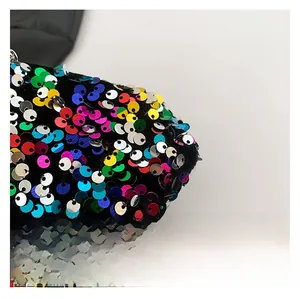 Detail of high-density colorful sequins on premium fabric for a trendy crossbody bag