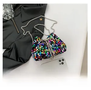 Detail view of colorful sequin bucket bag with silver chain strap and drawstring closure