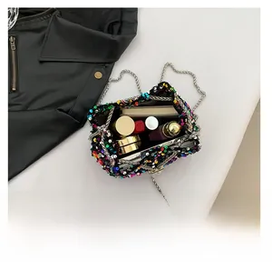 Internal view of sequined bucket bag showing phone, lipstick, and cosmetics storage