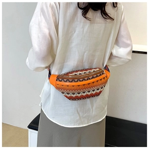 Rear view of ethnic embroidery waist bag with colorful bohemian patterns and orange leather trim