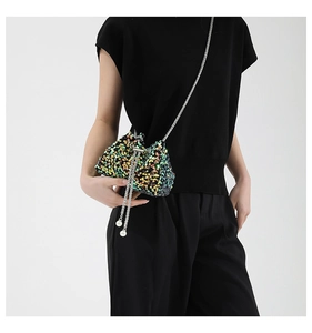 Detail of a mini sequin bucket bag featuring colorful laser sequins and pearl drawstring