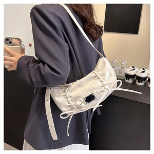 Vue détaillée du sac à bandoulière en PU blanc crème avec fronces, nœuds et plaque métal