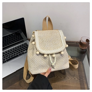 Beige woven straw backpack with decorative wooden beads and woven shoulder straps