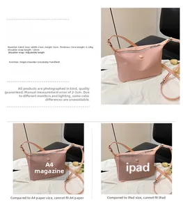 Detailed view of pink fabric crossbody bag with dimensions 23x16x10cm and adjustable strap