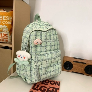 Green corduroy backpack with plaid pattern and cute plush charms for daily leisure