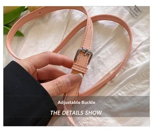 Detailed shot of adjustable pink leather strap with silver buckle and refined stitching