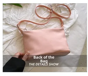 Detailed back view of pink lightweight nylon crossbody bag with adjustable strap