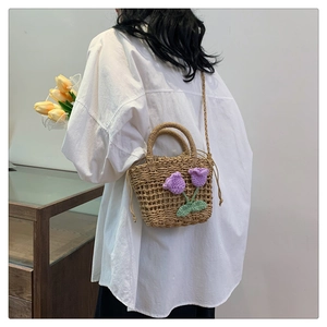 Detail of straw woven handbag with handmade crochet tulip and white shirt outfit
