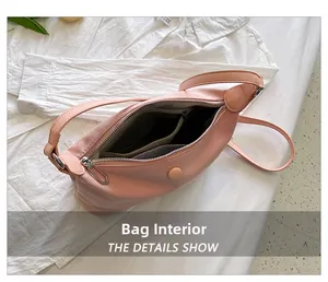 Detail view of the pink shoulder bag interior compartments and zipper pockets