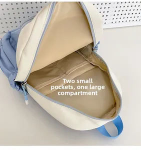 Detail view of backpack interior with two small pockets and one large compartment