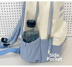 Detail view of the deep side pocket on a blue and white canvas backpack holding a water bottle