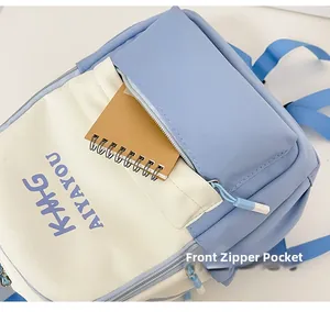 Close-up of front zipper pocket on blue and white canvas backpack with a notebook