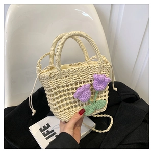 Fashionable straw woven handbag with purple crochet tulips and drawstring closure